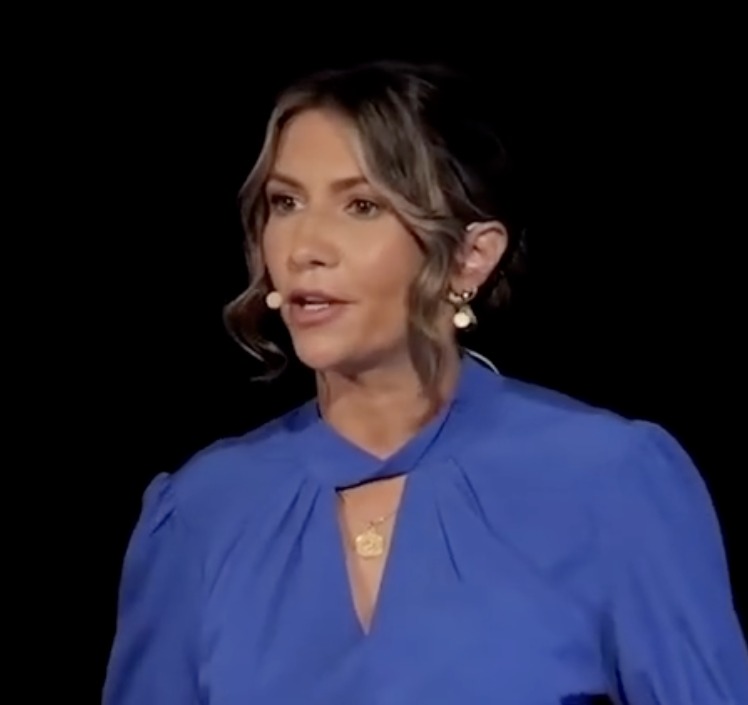 Larissa speaking on the TEDx stage